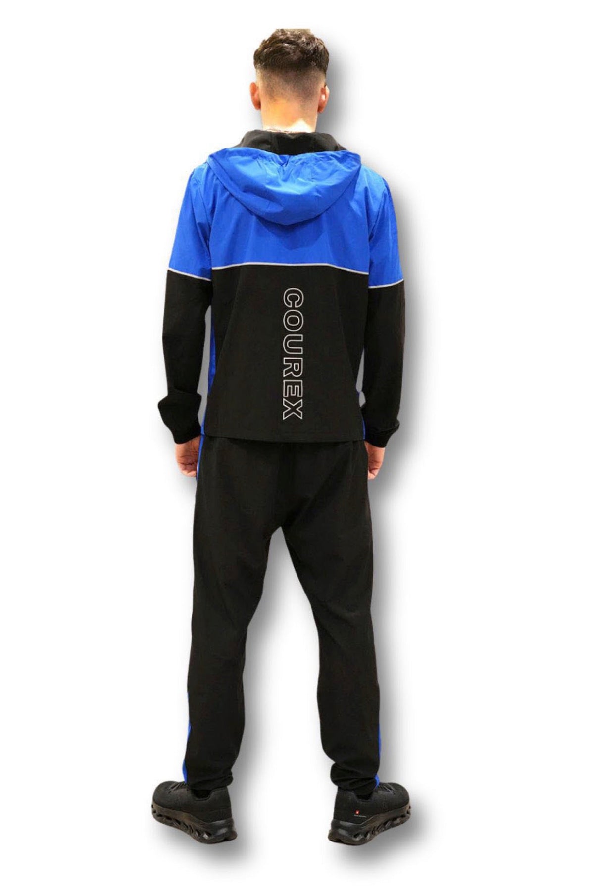 Full-length back view of the Courex Strive Tracksuit in black and blue